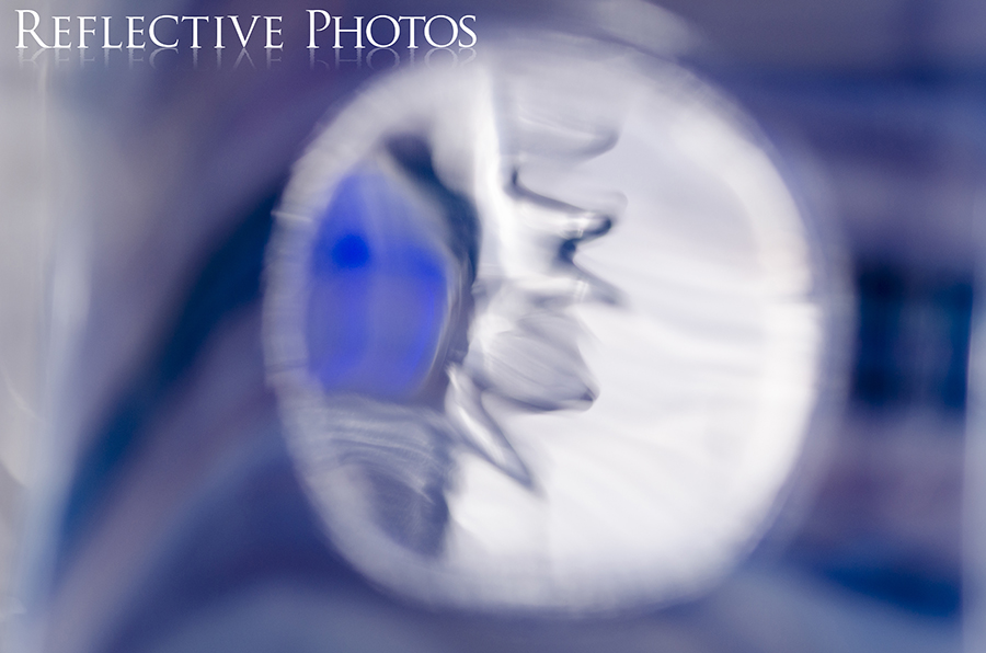 The spikey back of a glass seahorse is reflected into a glass surface to create this abstract photograph.